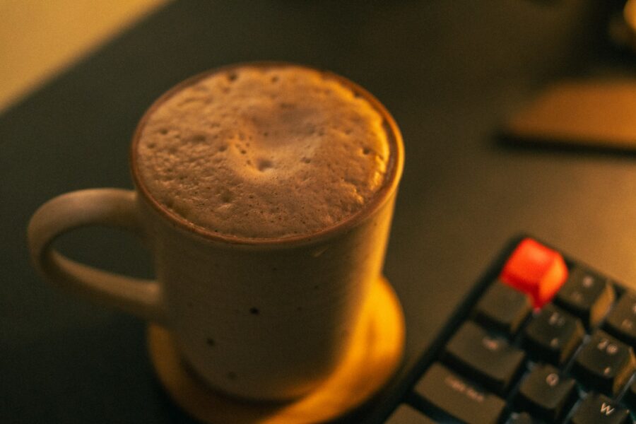 Indie game developers workspace monitors keyboard coffee