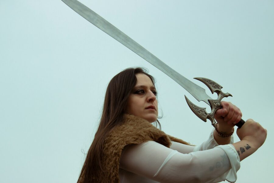 Fantasy rpg character inspecting sword inventory screen