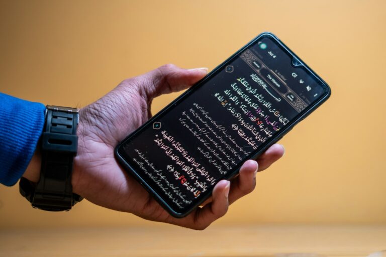 Hand holding smartphone mobile game rewards calendar