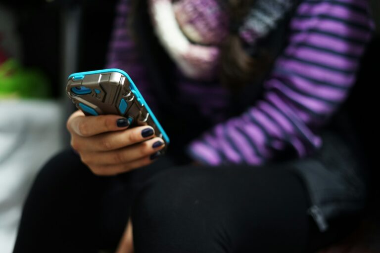 Teenager holding smartphone